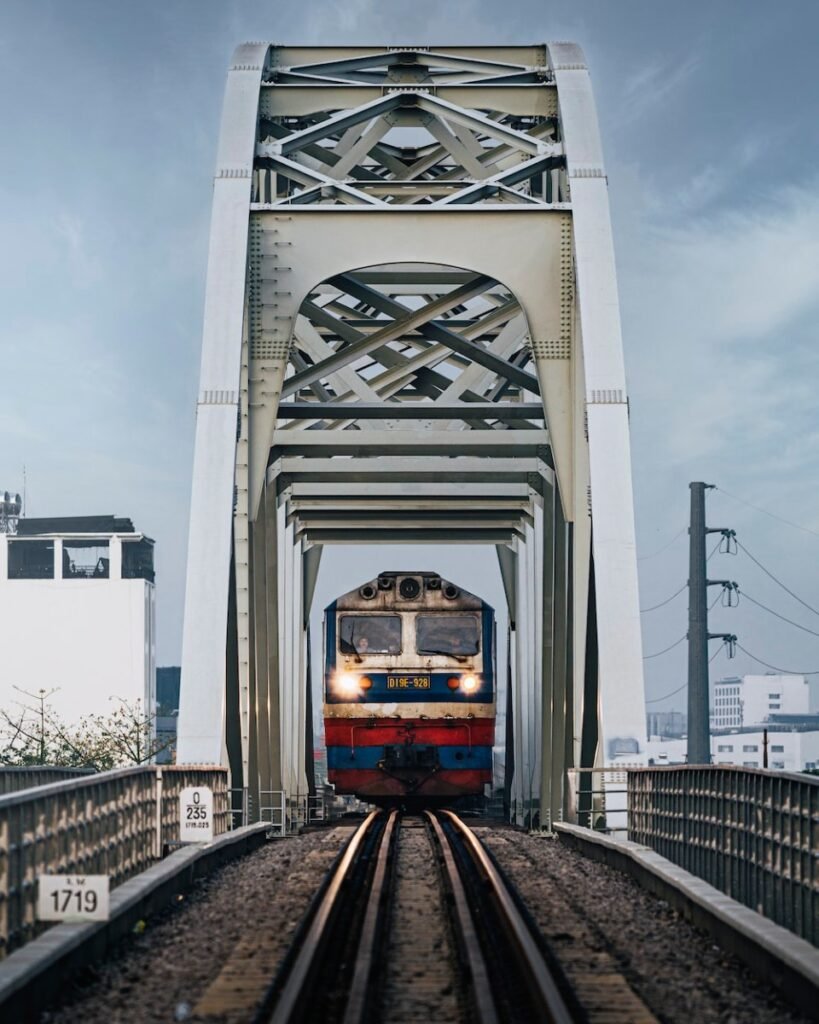 Train beneath the bridge in Binh Loi HCMC. Photo by Jet Dela Cruz - Ho Chi Minh City Transport | How to Get Around Saigon