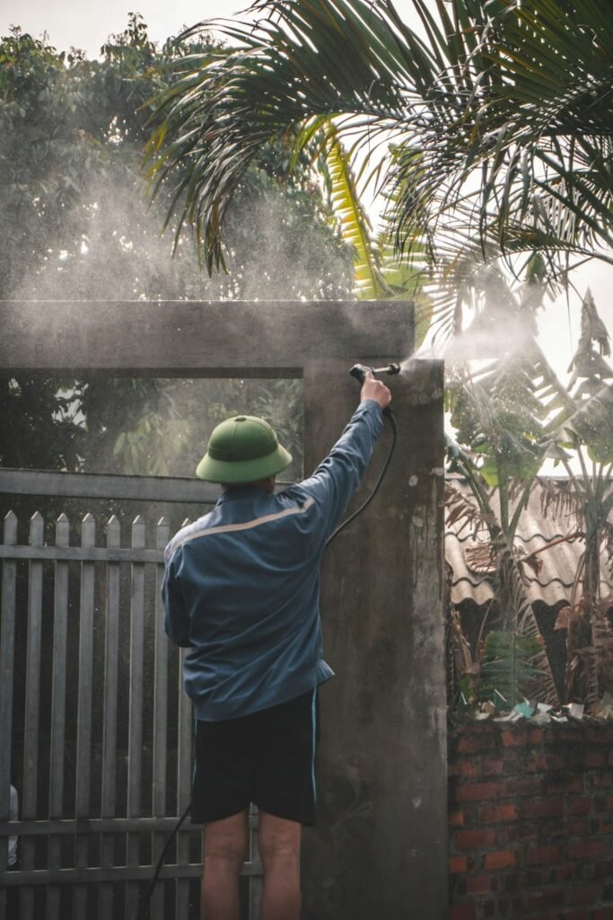 A man cleaning his gate. Photo by Cuong Do - Vietnamese New Year – Tet Guide For A Distinctive Lunar New Year Festival