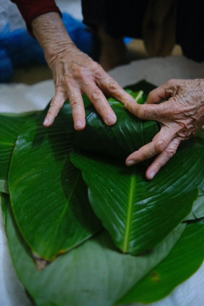 Wraping banh chung. Photo by Pham Manh2 - Vietnamese New Year – Tet Guide For A Distinctive Lunar New Year Festival