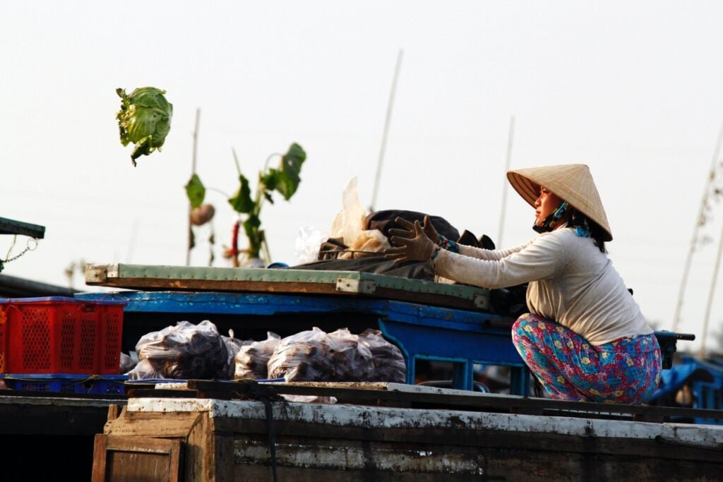 Floating Market Flying Lettuce. Photo by Hamzy Selamat - Top Cities in South Vietnam: The Ultimate Travel Guide